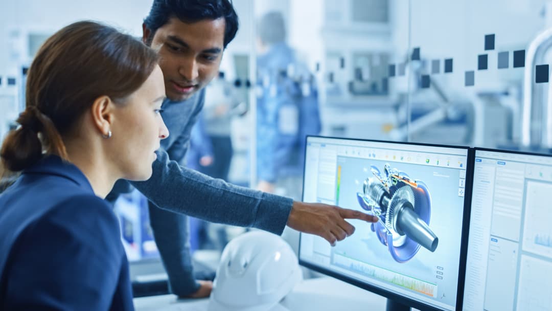 Man shows woman a product configured with CPQ on the monitor.