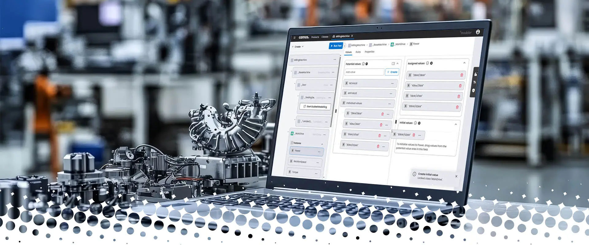 Open laptop with a modeling tool displayed on a table in a modern industrial environment. In the background, blurred machines and manufacturing components are visible; in the foreground, a complex machine part lies next to the laptop.